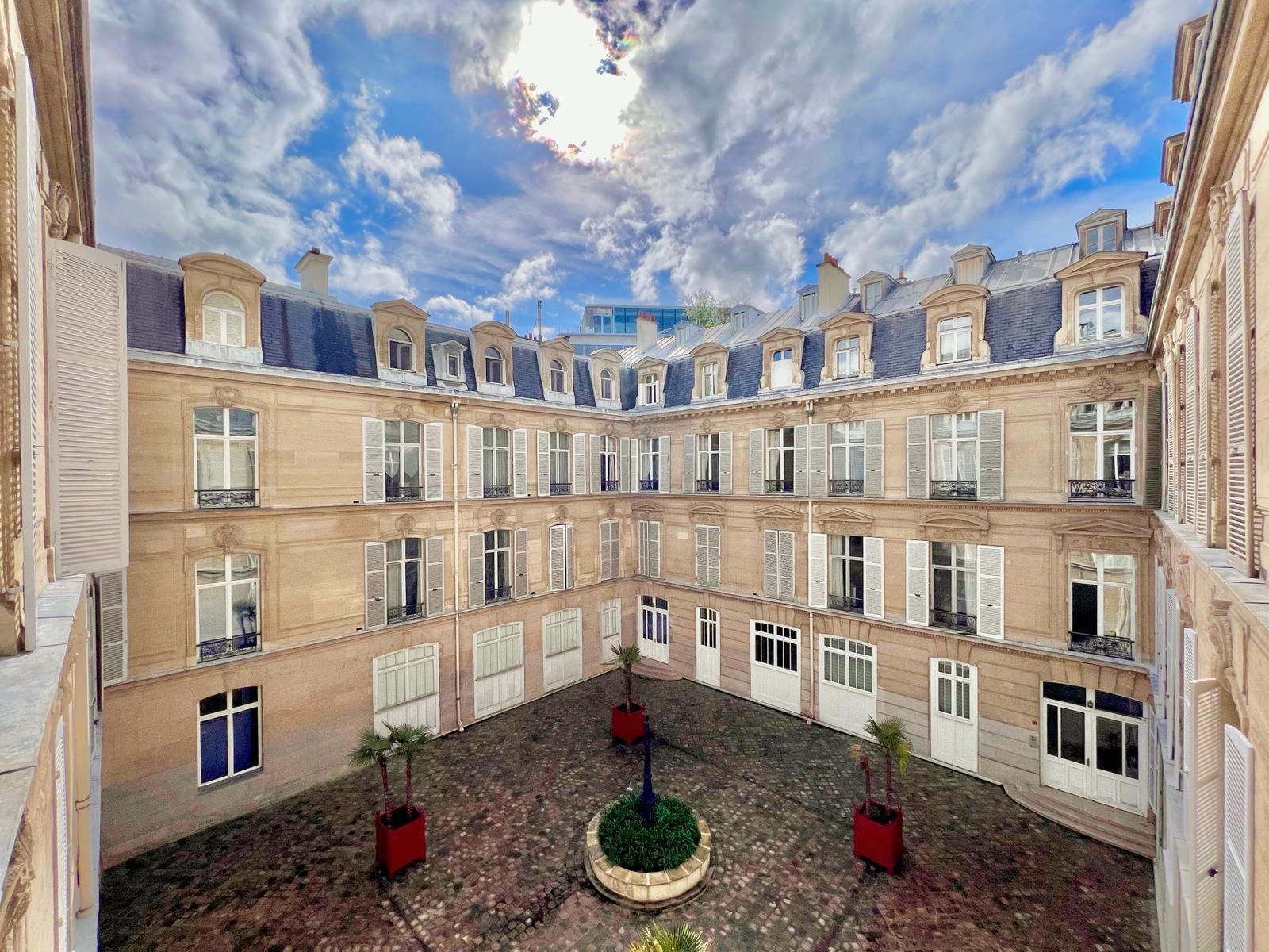 Woman in white blazer looking at property